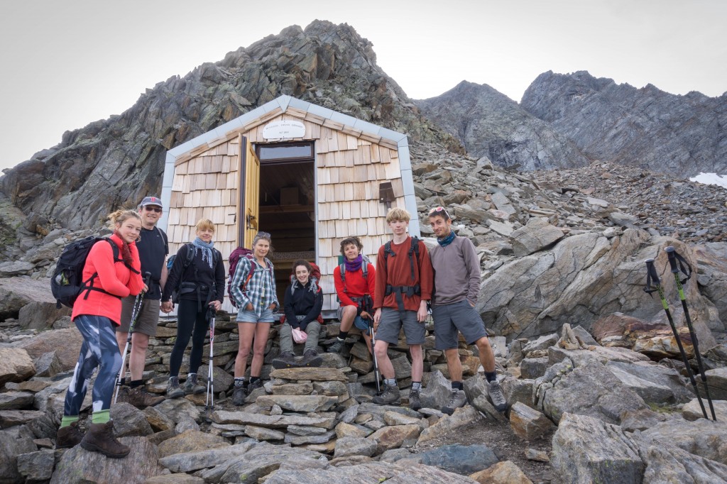 hikers posing in front of a small mountain hut in Gran Paradiso National Park