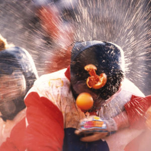 One of the team members getting hit with oranges during the battle of oranges