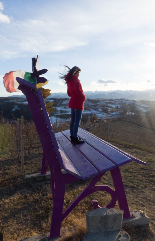 Big Benches in Piedmont include this purple big bench with lady standing on large bench which shows perspective of size